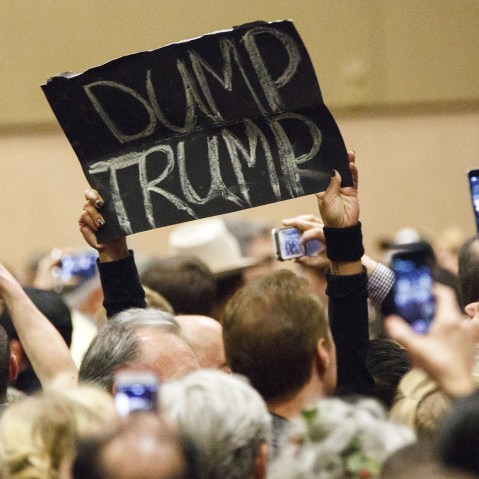 A protester's sign reads "Dump Trump" during a campaign rally for Donald Trump on Dec. 14, 2015. (Photo by Patrick T. Fallon/Bloomberg/Getty)