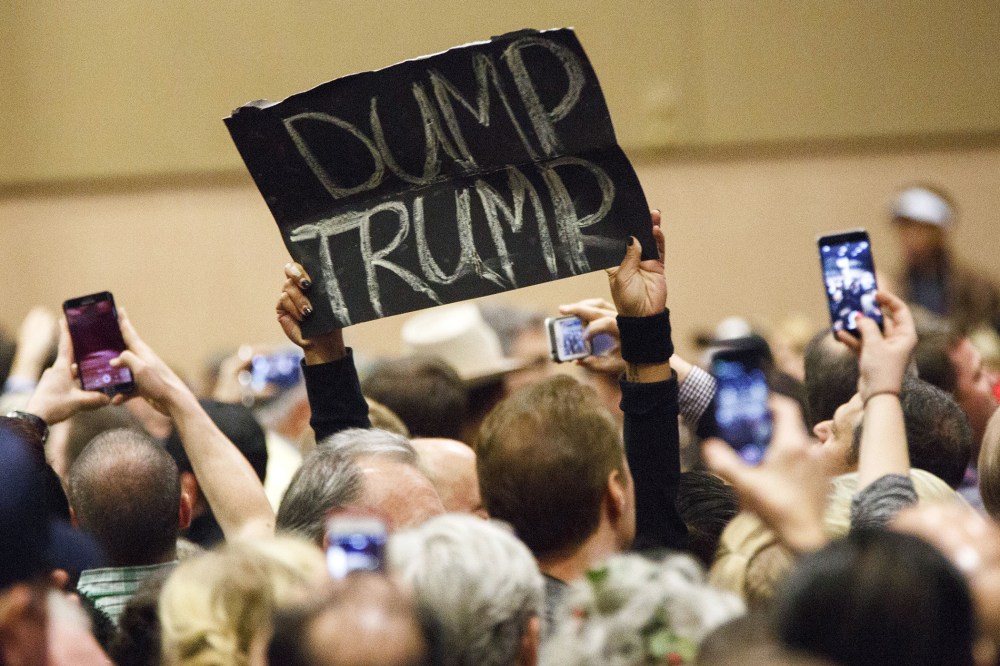 A protester's sign reads "Dump Trump" during a campaign rally for Donald Trump on Dec. 14, 2015. (Photo by Patrick T. Fallon/Bloomberg/Getty)