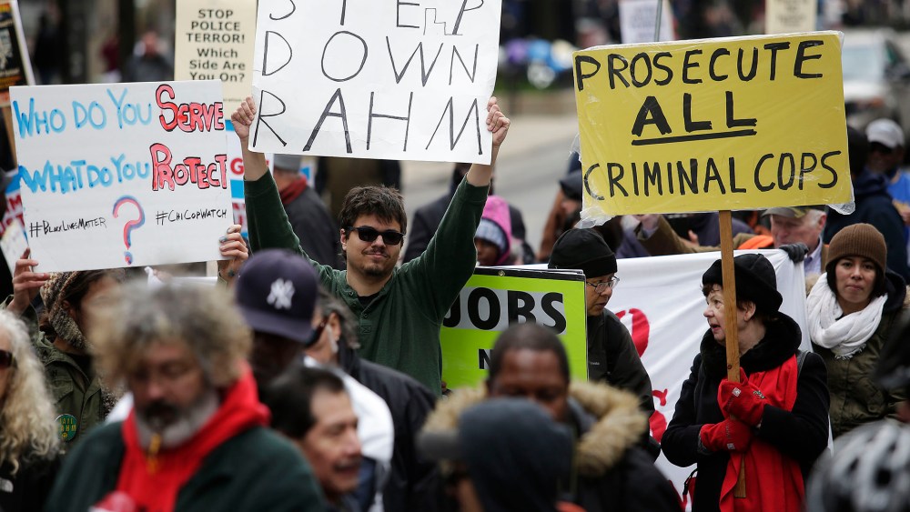 Demonstrators continue to protest the fatal police shooting of Laquan McDonald as they attempt to disrupt holiday shoppers along Michigan Avenue Dec. 24, 2015 in Chicago, Ill. (Photo by Joshua Lott/Getty)