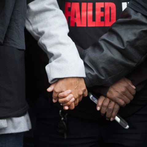 Janet Cooksey is comforted during a press conference about the deaths of her son Quintonio LeGrier, and Bettie Jones before the start of a vigil on Dec. 27, 2015 in Chicago, Ill. (Photo by Scott Olson/Getty)