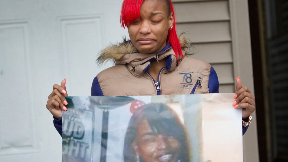 LaTonya Jones, the daughter of Bettie Jones, holds a picture of her mother during a vigil outside her home on Dec. 27, 2015 in Chicago, Ill. (Photo by Scott Olson/Getty)