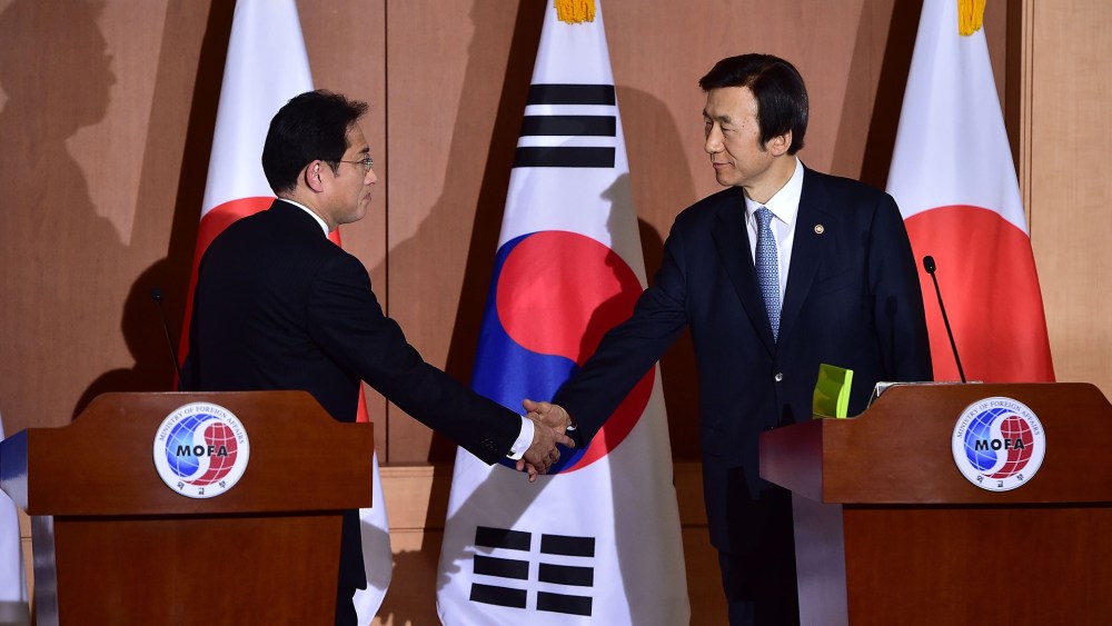 Japan's Foreign Minister Fumio Kishida shakes hands with his South Korean counterpart Yun Byung-Se after a joint press briefing at the Foreign Ministry in Seoul, Dec. 28, 2015. (Photo by Jung Yeon-Je/AFP/Getty)
