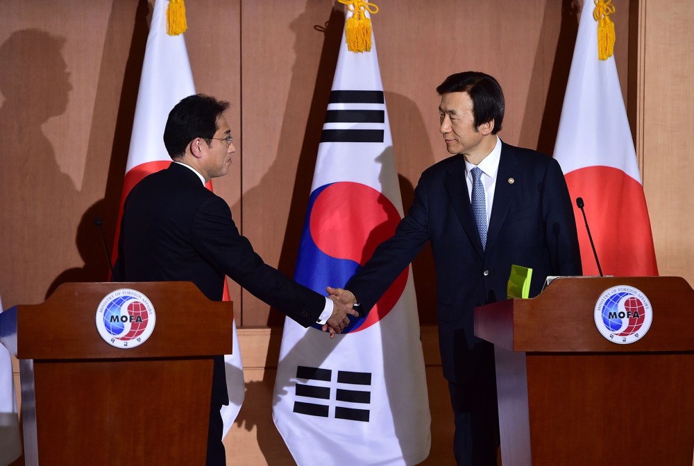 Japan's Foreign Minister Fumio Kishida shakes hands with his South Korean counterpart Yun Byung-Se after a joint press briefing at the Foreign Ministry in Seoul, Dec. 28, 2015. (Photo by Jung Yeon-Je/AFP/Getty)