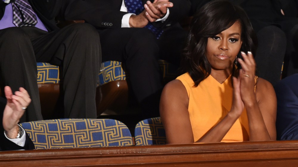 First Lady Michelle Obama sits next to a vacant seat to honor victims of gun violence during President Barack Obama’s State of the Union on Capitol Hill in Washington, Jan. 12, 2016. (Photo by Nicholas Kamm/AFP/Getty)