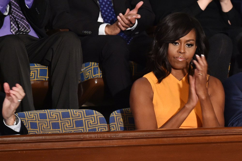 First Lady Michelle Obama sits next to a vacant seat to honor victims of gun violence during President Barack Obama’s State of the Union on Capitol Hill in Washington, Jan. 12, 2016. (Photo by Nicholas Kamm/AFP/Getty)