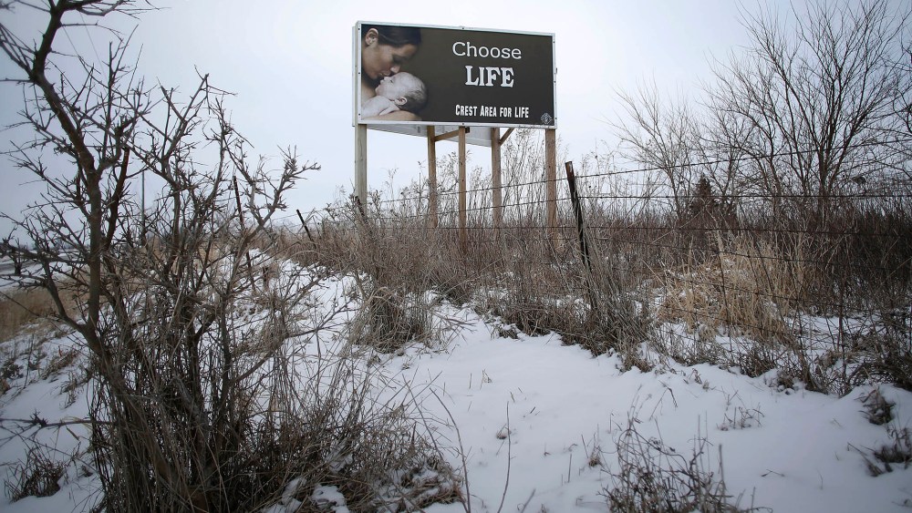 A "Chose Life" advertisement is displayed along a snow covered U.S. Highway 34 on Jan. 22, 2016 in Thayer, Iowa. (Photo by Joshua Lott/Getty)
