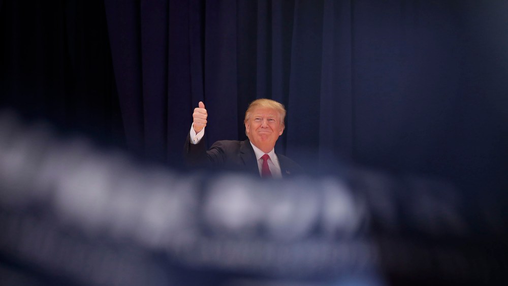 Republican presidential candidate Donald Trump gives a thumbs-up as he is introduced during a campaign event Jan. 23, 2016 in Pella, Ia. (Photo by Joshua Lott/Getty)