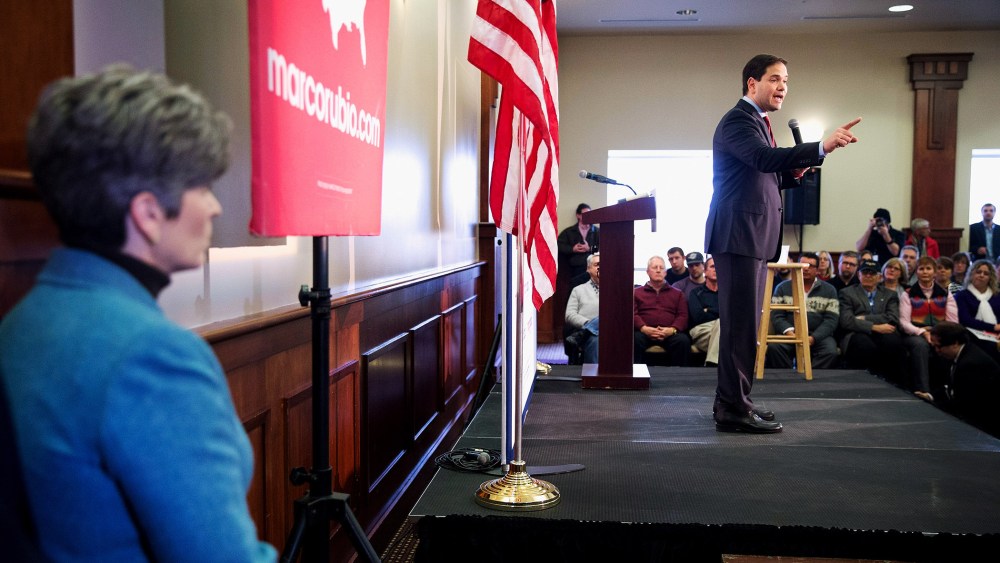 Sen. Joni Ernst (R-IA) listens as Republican presidential candidate Sen. Marco Rubio (R-FL) speaks at a rally on Jan. 25, 2016 in Des Moines, Iowa. (Photo by Scott Olson/Getty)
