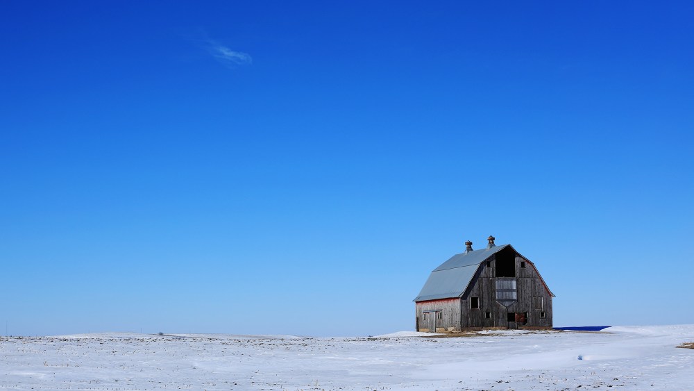 A traditional barn adorns the snow covered vast grand plains of Iowa on Jan. 29, 2016 in Carrol County, Iowa. (Photo by Christopher Furlong/Getty)