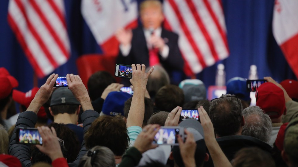 People photograph Republican presidential candidate Donald Trump with their smart phones as he speaks to guests during a campaign rally at the Gerald W. Kirn Middle School on Jan. 31, 2016 in Council Bluffs, Iowa. (Photo by Christopher Furlong/Getty)
