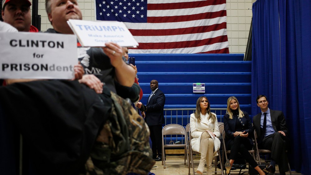 As Donald Trump speaks, wife Melania Trump, seated left, daughter Ivanka Trump, daughter of Donald Trump, seated center, and son-in-law Jared Kushner listen offstage during a campaign rally in Council Bluffs, Iowa, U.S., on Jan. 31, 2016.