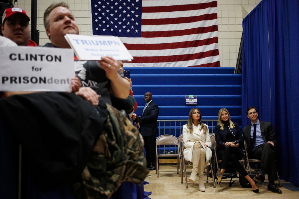 As Donald Trump speaks, wife Melania Trump, seated left, daughter Ivanka Trump, daughter of Donald Trump, seated center, and son-in-law Jared Kushner listen offstage during a campaign rally in Council Bluffs, Iowa, U.S., on Jan. 31, 2016.