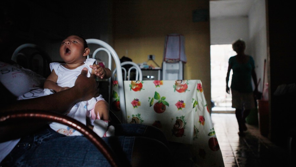 Alice Vitoria Gomes Bezerra, 3-months-old, who has microcephaly, is held by her mother Nadja Cristina Gomes Bezerra on Jan. 31, 2016 in Recife, Brazil. (Photo by Mario Tama/Getty)