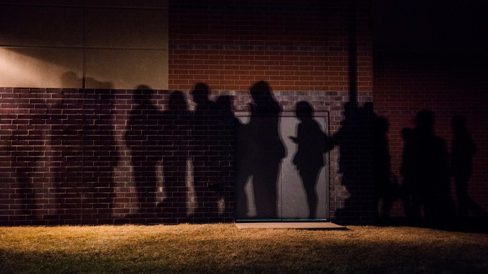 The shadows of caucus goers lined up outside a Democrat Party caucus can be seen on the walls of Maple Grove Elementary in West Des Moines, Iowa. (Photo by Stephen Maturen/Getty)