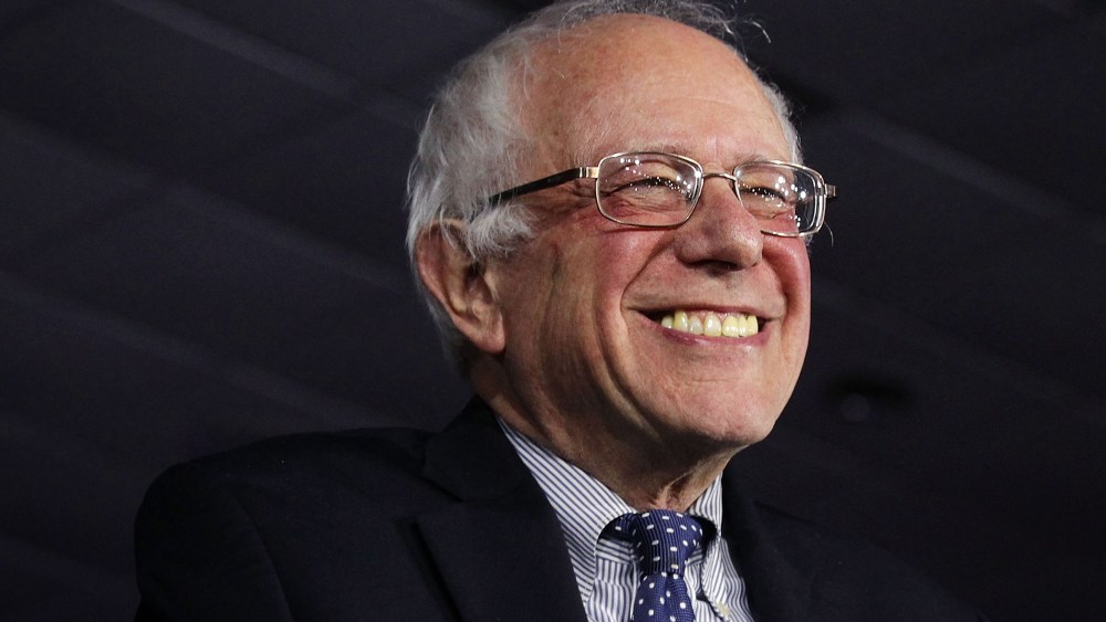 Democratic presidential candidate Sen. Bernie Sanders (I-VT) smiles as he speaks to supporters during a caucus night party Feb. 1, 2016 in Des Moines, Iowa. (Photo by Alex Wong/Getty)