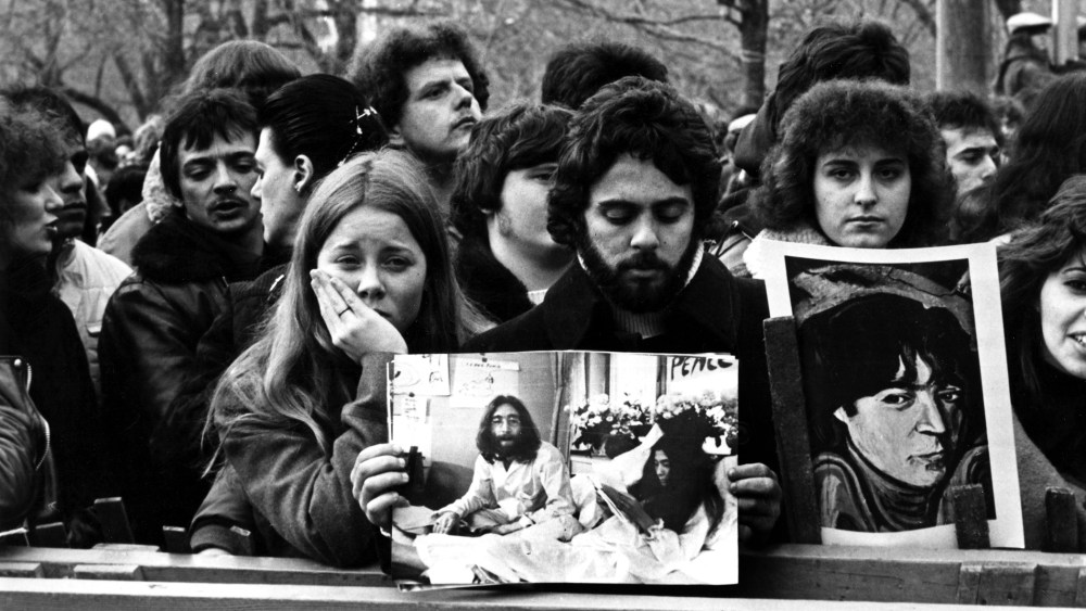 People line up to commemorate John Lennon in Central Park in New York after his death in 1980. (Photo by AGIP/RDA/Getty)
