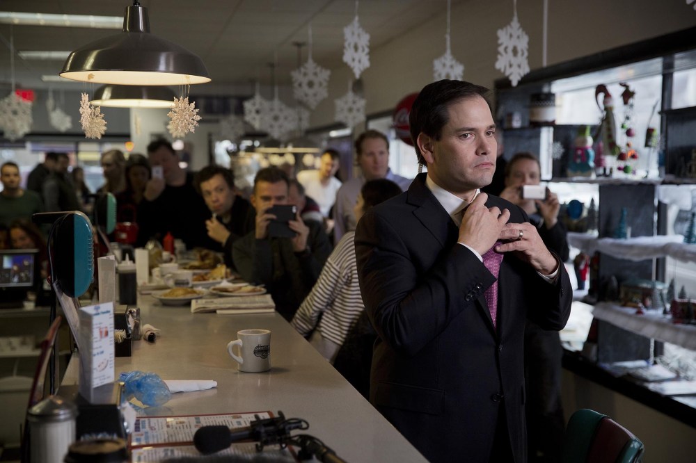 Senator Marco Rubio, a Republican from Florida and 2016 presidential candidate, adjusts his tie before an interview during a campaign stop at Norton's Cafe in Nashua, N.H., U.S., Feb. 8, 2016. (Photo by Victor J. Blue/Bloomberg/Getty)
