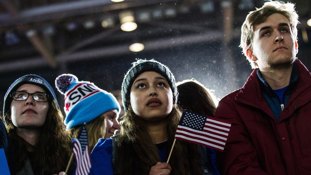 Audience members listen to Democratic presidential hopeful, Sen. Bernie Sanders (D-VT) speak at a campaign rally and concert on Feb. 8, 2016 in Durham, N.H. (Photo by Andrew Burton/Getty)