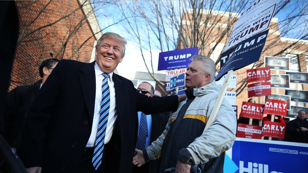 Republican presidential candidate Donald Trump greets people as he visits a polling station as voters cast their primary day ballots on Feb. 9, 2016 in Manchester, N.H. (Photo by Joe Raedle/Getty)