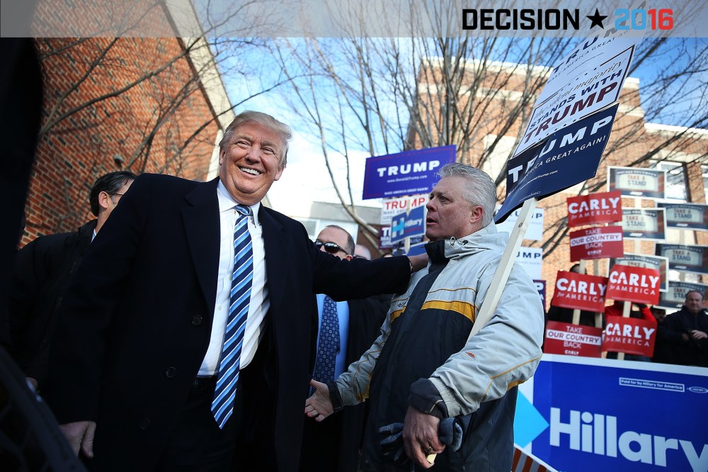 Republican presidential candidate Donald Trump greets people as he visits a polling station as voters cast their primary day ballots on Feb. 9, 2016 in Manchester, N.H. (Photo by Joe Raedle/Getty)
