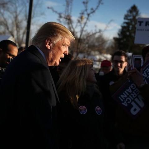 Republican presidential candidate Donald Trump greets people as he visits a polling station as voters cast their primary day ballots on Feb. 9, 2016 in Manchester, N.H. (Photo by Joe Raedle/Getty)