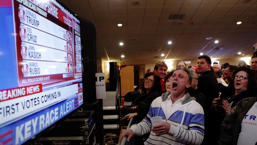Trump supporters cheer as a television screen shows early poll numbers at Trump's election night rally on Feb. 9, 2016 in Manchester, N.H. (Photo by Matthew Cavanaugh/Getty)