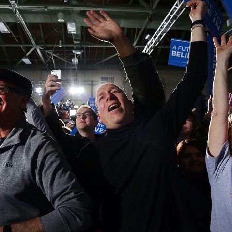 People cheer as Sen. Bernie Sanders (D-VT) speaks onstage after victory over Hillary Clinton in the New Hampshire primary on Feb. 9, 2016 in Concord, N.H. (Photo by Spencer Platt/Getty)