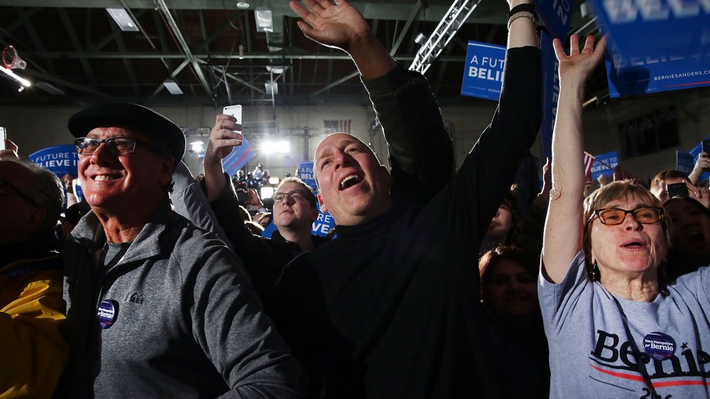 People cheer as Sen. Bernie Sanders (D-VT) speaks onstage after victory over Hillary Clinton in the New Hampshire primary on Feb. 9, 2016 in Concord, N.H. (Photo by Spencer Platt/Getty)