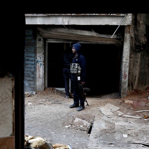 A rebel fighter, reportedly belonging to the Fajr al- Ummah brigade, holds his weapon as he stands on a street on Feb. 10, 2016 in Harasta, east of the capital Damascus. (Photo by Abdulmonam Eassa/AFP/Getty)