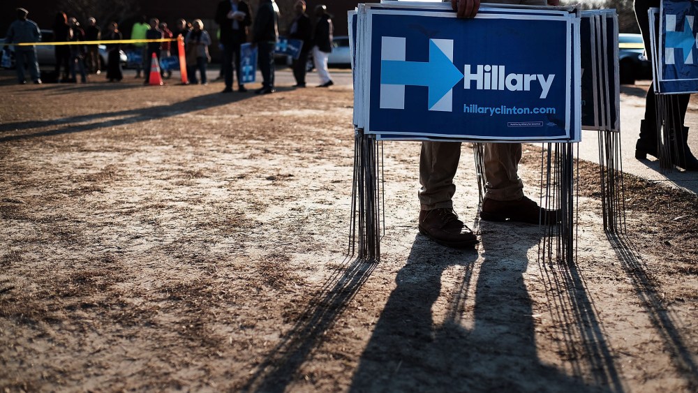 Campaign workers try to pass out signs following an appearance by Democratic presidential candidate Hillary Clinton on Feb. 12, 2016 in Denmark, S.C. (Photo by Spencer Platt/Getty)