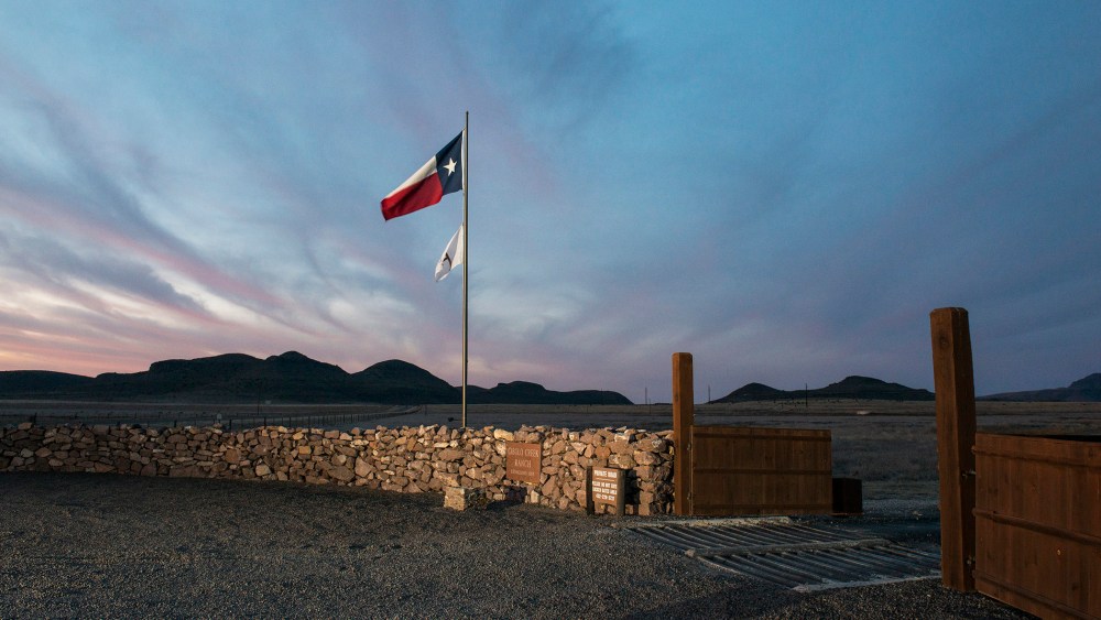 The Texas flag flies at the entrance to the Cibolo Creek Ranch in Shafter, Texas. (Photo by Matthew Busch/Getty)