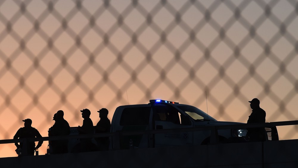 U.S. Border Patrol officers keep along the border fence separating U.S. and Mexico in the town of El Paso, Texas on Feb. 17, 2016. (Photo by Mark Ralston/AFP/Getty)