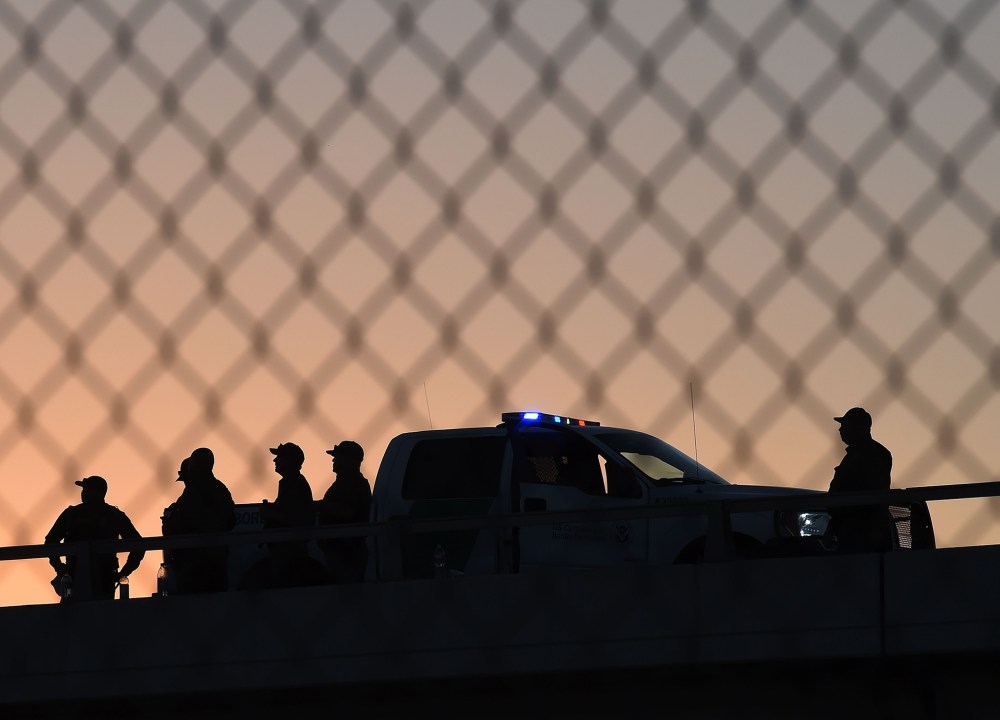 U.S. Border Patrol officers keep along the border fence separating U.S. and Mexico in the town of El Paso, Texas on Feb. 17, 2016. (Photo by Mark Ralston/AFP/Getty)