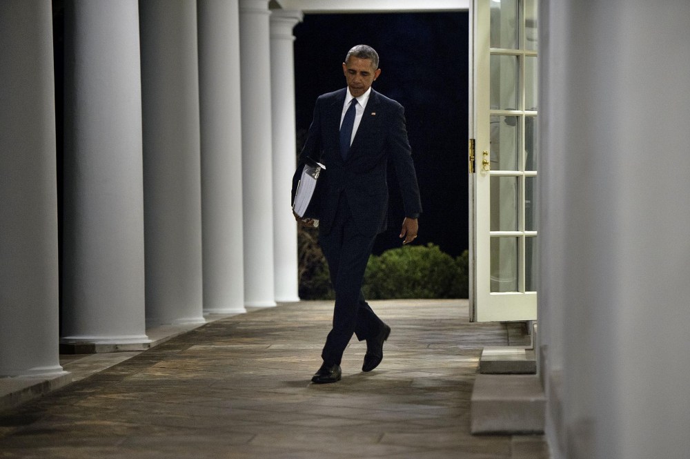 President Obama walks from the West Wing to the residence of the White House with a binder of potential Supreme Court nominees in Washington, Feb. 19, 2016. (Photo by Brendan Smialowski/AFP/Getty)