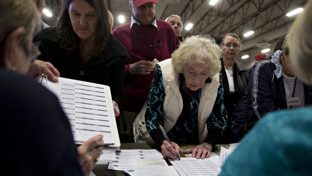 Caucusgoers check-in to receive a ballot at the Cimarron-Memorial High School caucus location during the Nevada Republican presidential caucus in Las Vegas, Nev., on Feb. 23, 2016. (Photo by Andrew Harrer/Bloomberg/Getty)