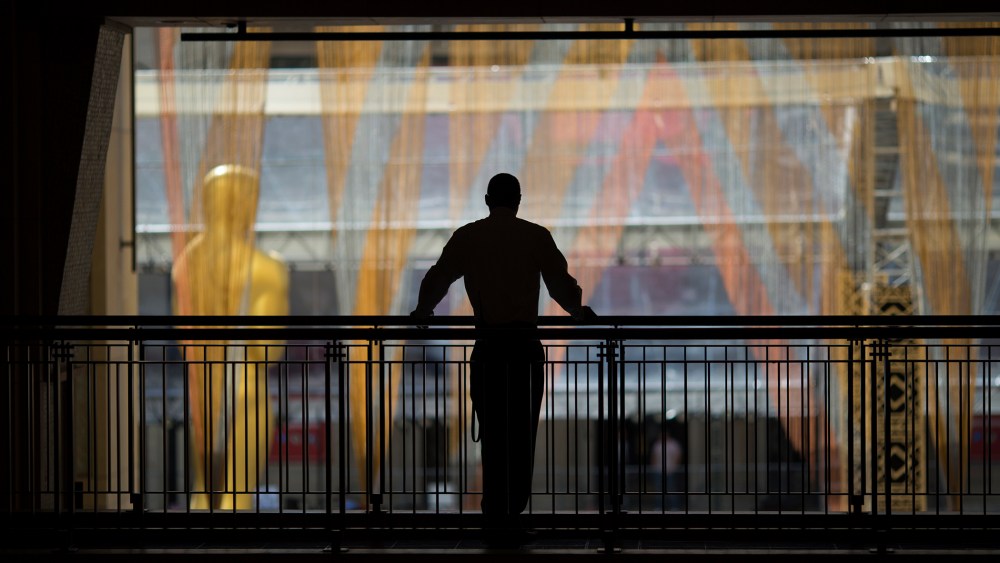 A security guard watches over operations near the primary Oscar statue as preparations are made for the 88th Annual Academy Awards at Hollywood & Highland Center on Feb. 24, 2016 in Hollywood, Calif. (Photo by David McNew/Getty)
