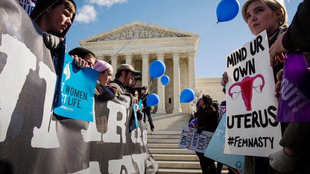 Pro-choice advocates and anti-abortion advocates rally outside of the Supreme Court, March 2, 2016 in Washington, DC. (Photo by Drew Angerer/Getty)