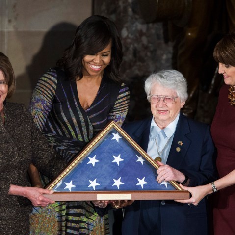 House Minority Leader Nancy Pelosi (D-CA) and First Lady Michelle Obama present an American flag to retired Air Force Brigadier Gen. Wilma Vaught on Capitol Hill, March 2, 2016 in Washington, DC. (Photo by Drew Angerer/Getty)