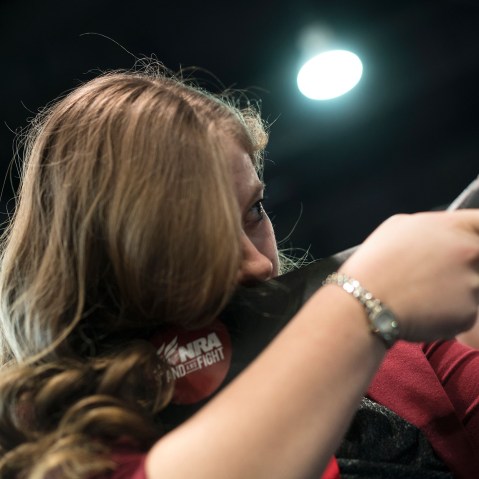 A woman uses a rifle in a laser shooting simulation by the NRA during the American Conservative Union Conservative Political Action Conference 2016, March 4, 2016, in Oxon Hill, Md. (Photo by Brendan Smialowski/AFP/Getty)