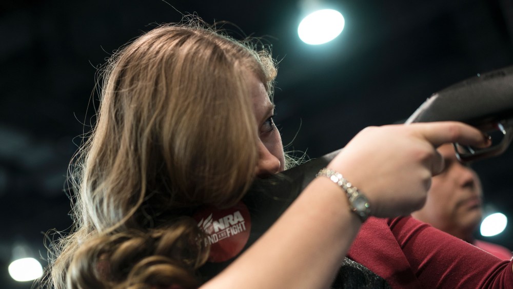 A woman uses a rifle in a laser shooting simulation by the NRA during the American Conservative Union Conservative Political Action Conference 2016, March 4, 2016, in Oxon Hill, Md. (Photo by Brendan Smialowski/AFP/Getty)