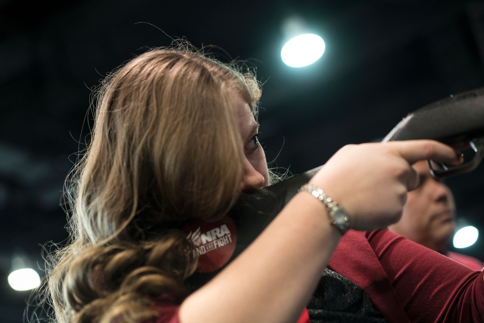 A woman uses a rifle in a laser shooting simulation by the NRA during the American Conservative Union Conservative Political Action Conference 2016, March 4, 2016, in Oxon Hill, Md. (Photo by Brendan Smialowski/AFP/Getty)