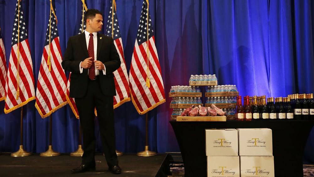 A security agent stands near a display Donald Trump brands before a press conference at the Trump National Golf Club Jupiter on March 8, 2016 in Jupiter, Fla. (Photo by Joe Raedle/Getty)