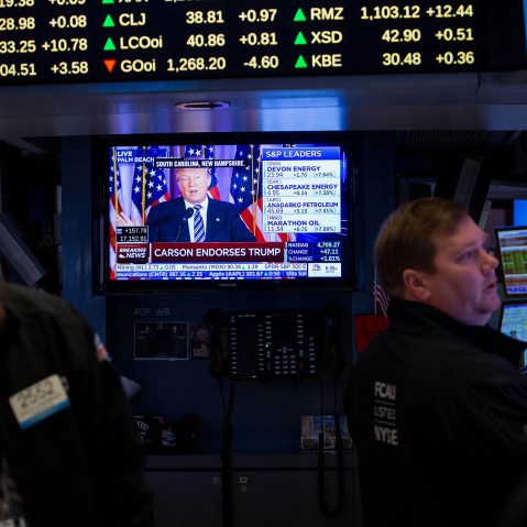 Donald Trump is seen speaking on a monitor as traders work on the floor of the New York Stock Exchange (NYSE) in New York, U.S., March 11, 2016. (Photo by Michael Nagle/Bloomberg/Getty)