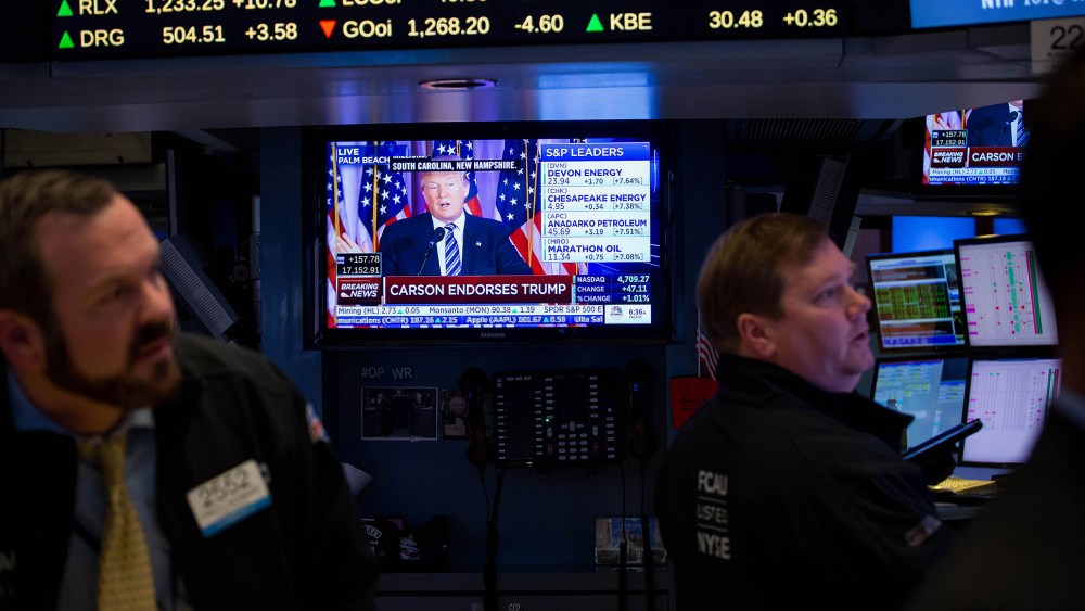 Donald Trump is seen speaking on a monitor as traders work on the floor of the New York Stock Exchange (NYSE) in New York, U.S., March 11, 2016. (Photo by Michael Nagle/Bloomberg/Getty)