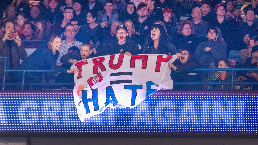 Demonstrators react after learning a rally for Republican presidential candidate Donald Trump at the University of Illinois at Chicago would be postponed on March 11, 2016 in Chicago, Ill. (Photo by Scott Olson/Getty)