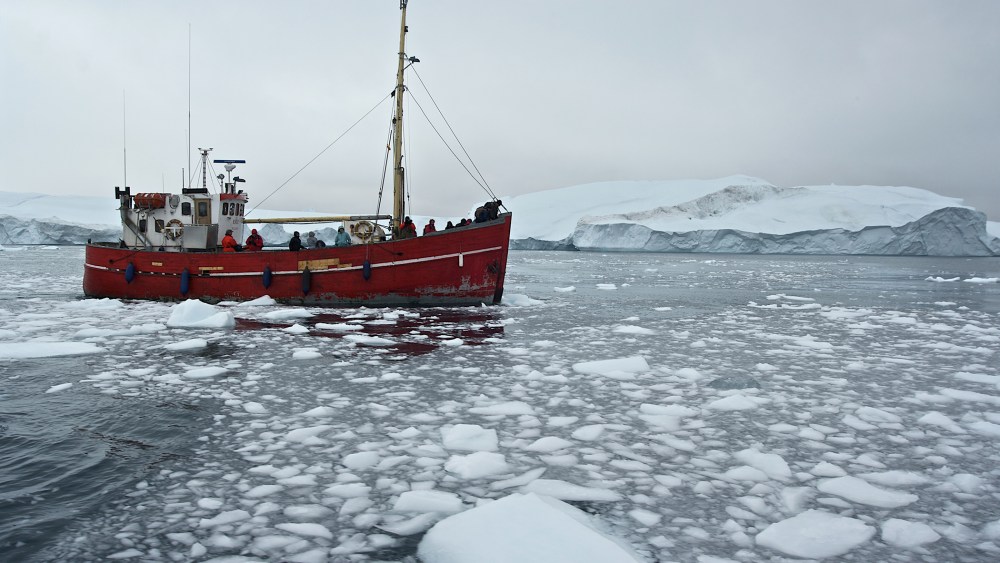 Ship among icebergs in Greenland. (Photo by DeAgostini/Getty)