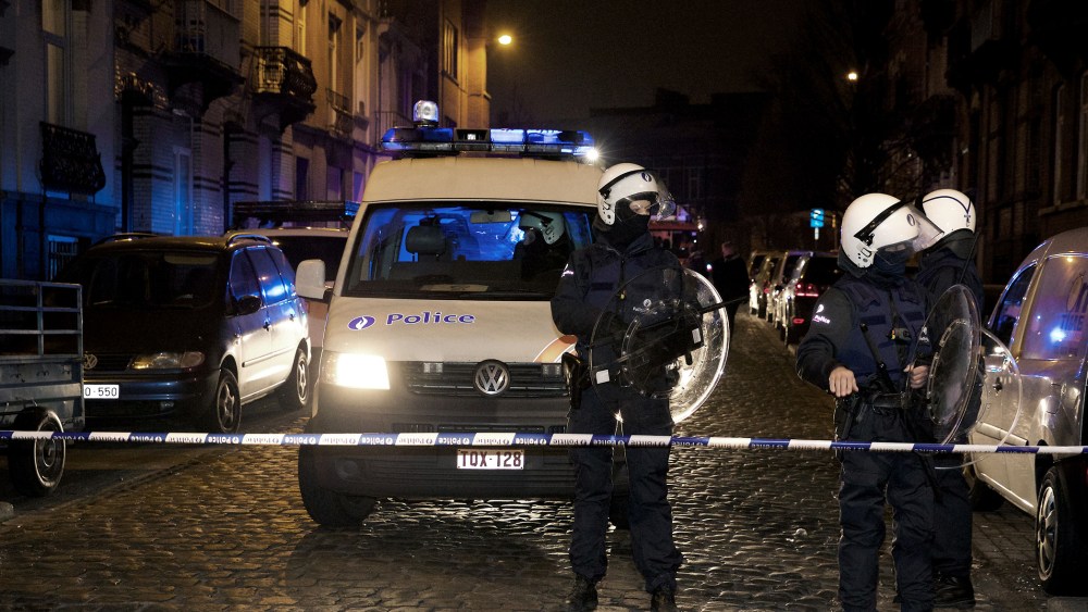 Policemen stand guard the street at Rue de la Carpe in Molenbeek-Saint-Jean in Brussels, on March 19, 2016. (Photo by Nicolas Maeterlinck/AFP/Getty)