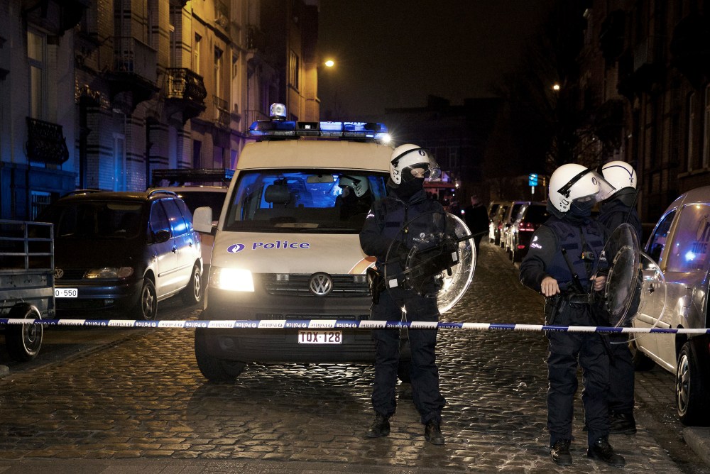 Policemen stand guard the street at Rue de la Carpe in Molenbeek-Saint-Jean in Brussels, on March 19, 2016. (Photo by Nicolas Maeterlinck/AFP/Getty)