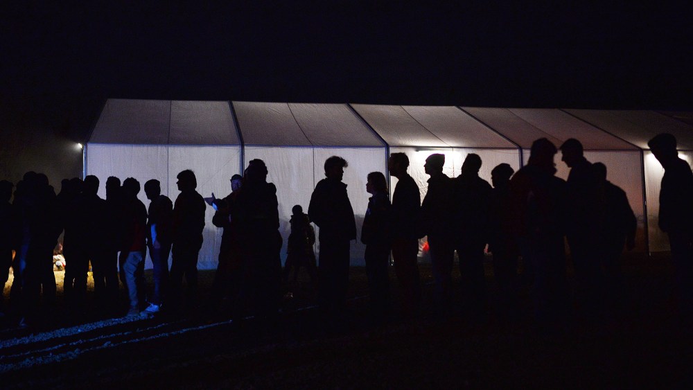 Migrants and refugees line up for soup in the makeshift camp at the Greek-Macedonian border near the village of Idomeni on March 20, 2016. (Photo by Louisa Gouliamaki/AFP/Getty)