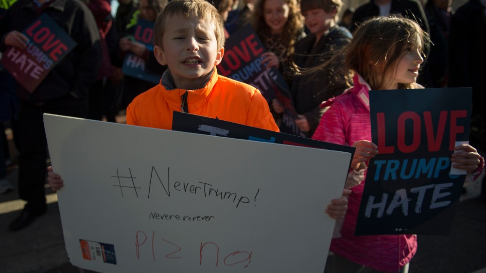 Ten-year-old Henry and seven-year-old Ruby protest outside Verizon Center where Republican presidentil candidate Donald Trump spoke during AIPAC 2016 Policy Conference on March 21, 2016 in Washington, DC. (Photo by Molly Riley/AFP/Getty)